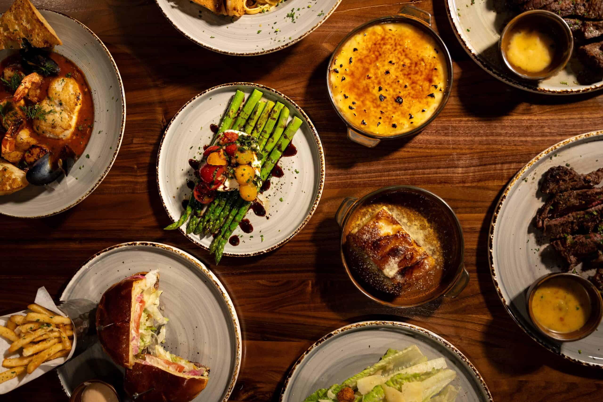dinner-spread-at-corona-steakhouse-with-seafood-asparagus-desserts